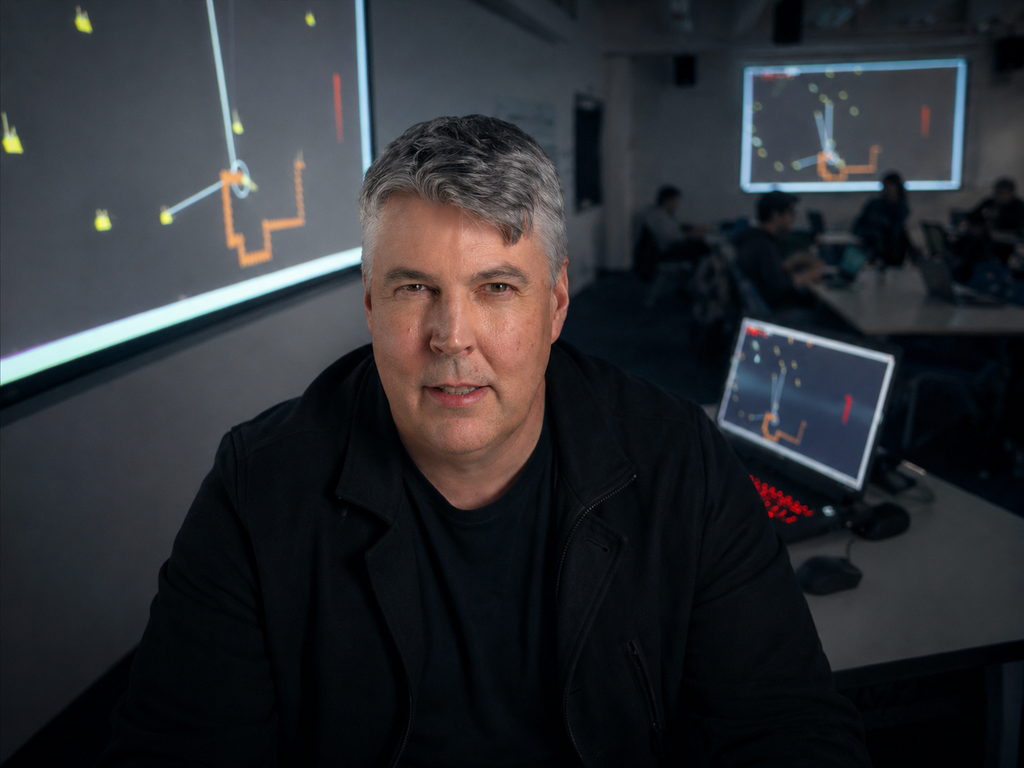 Eric Freeman in a creative coding classroom with projected student work