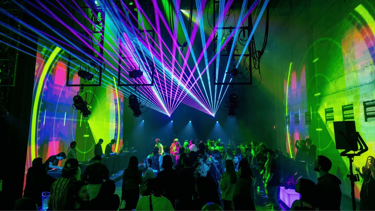 Live-coded visuals and laser projections fill a performance space